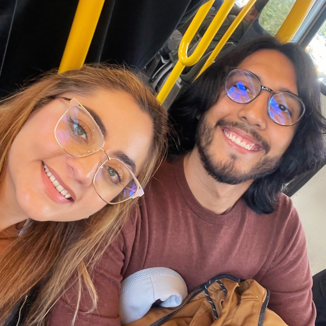 two people taking a selfie on a bus