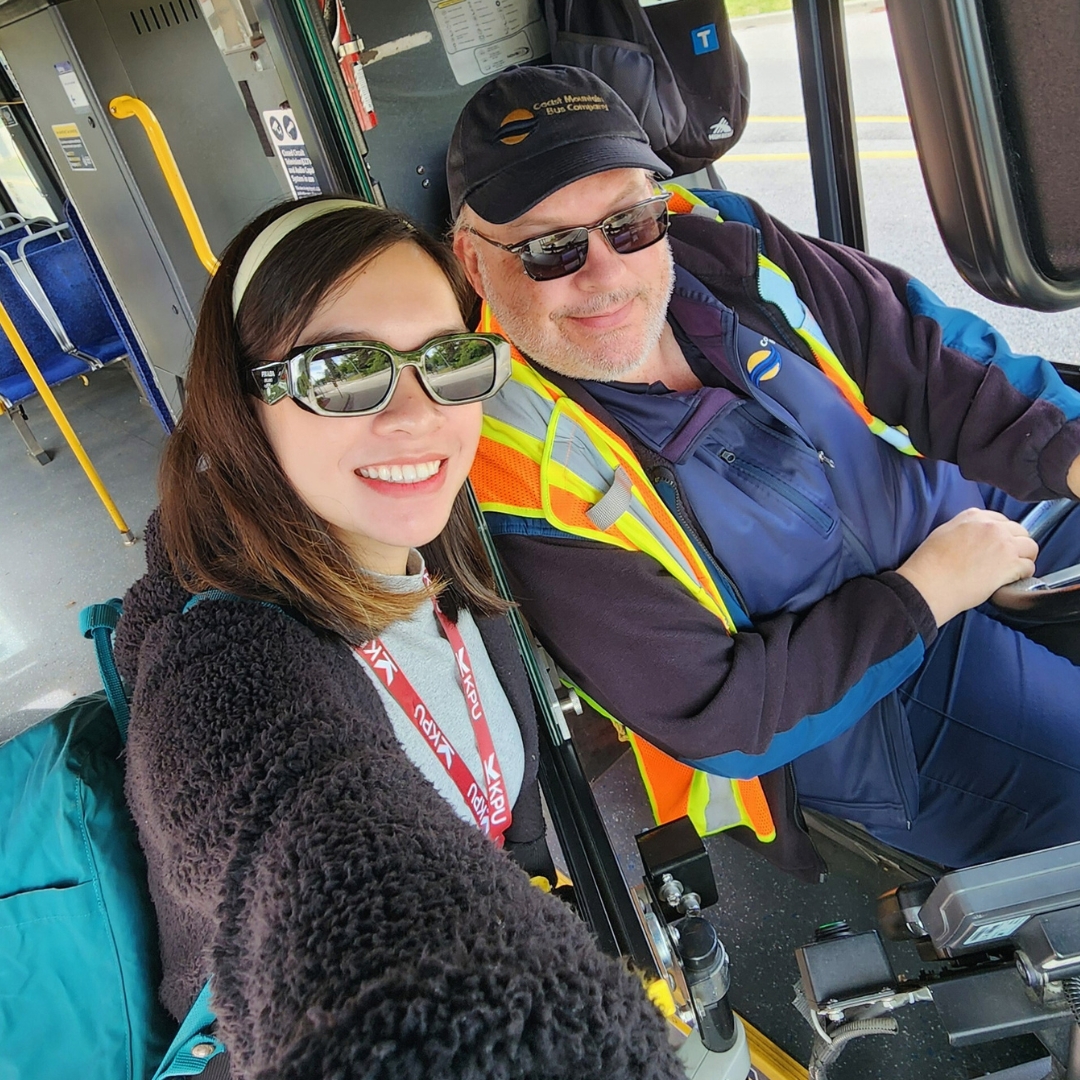 person taking selfie with a bus driver 