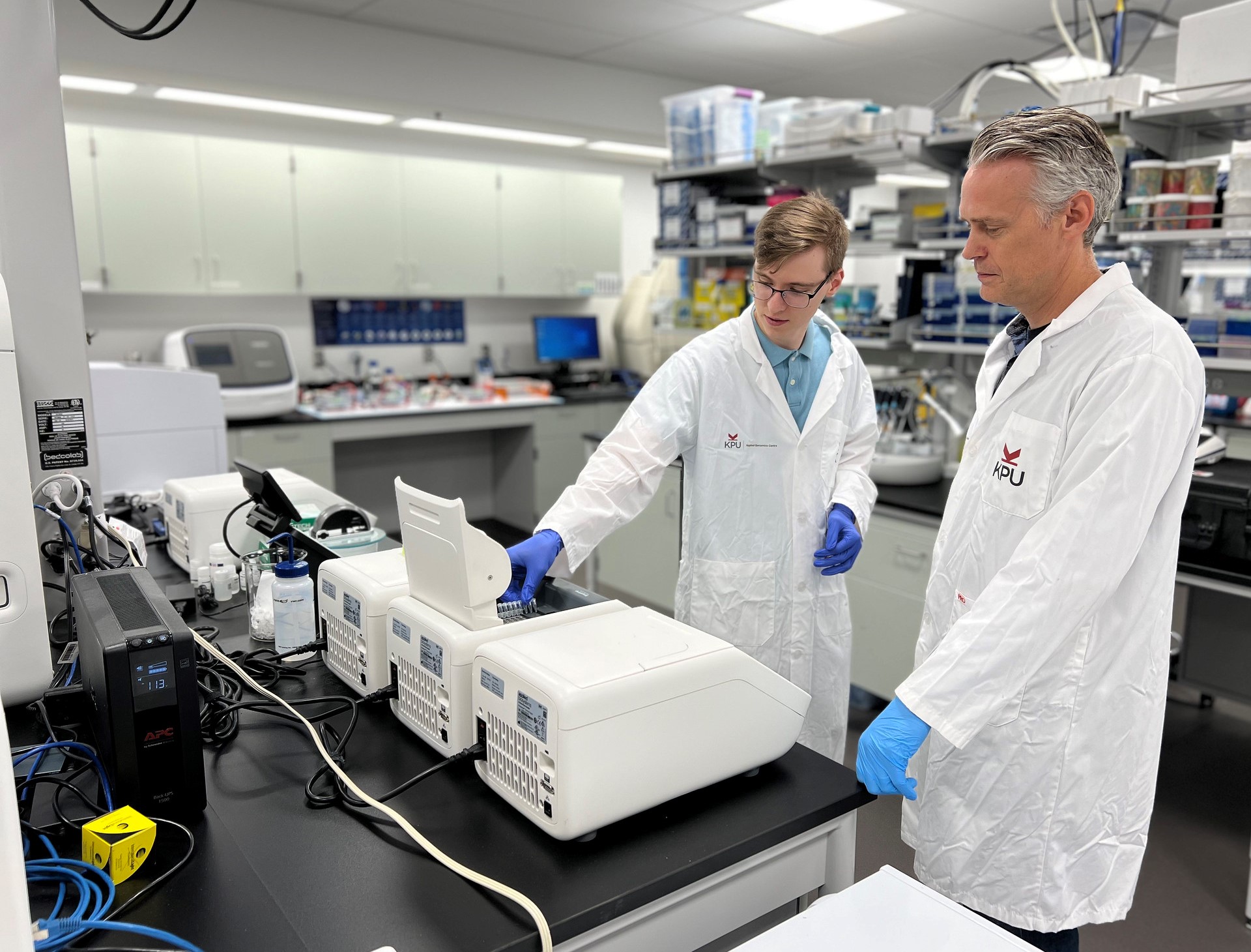 Dr. Paul Adams and Robert Wester using the Ion GeneStudio S5 System in KPU's Applied Genomics Centre.