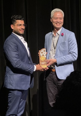 Shubham Chhabra receiving an award from Greg Chan