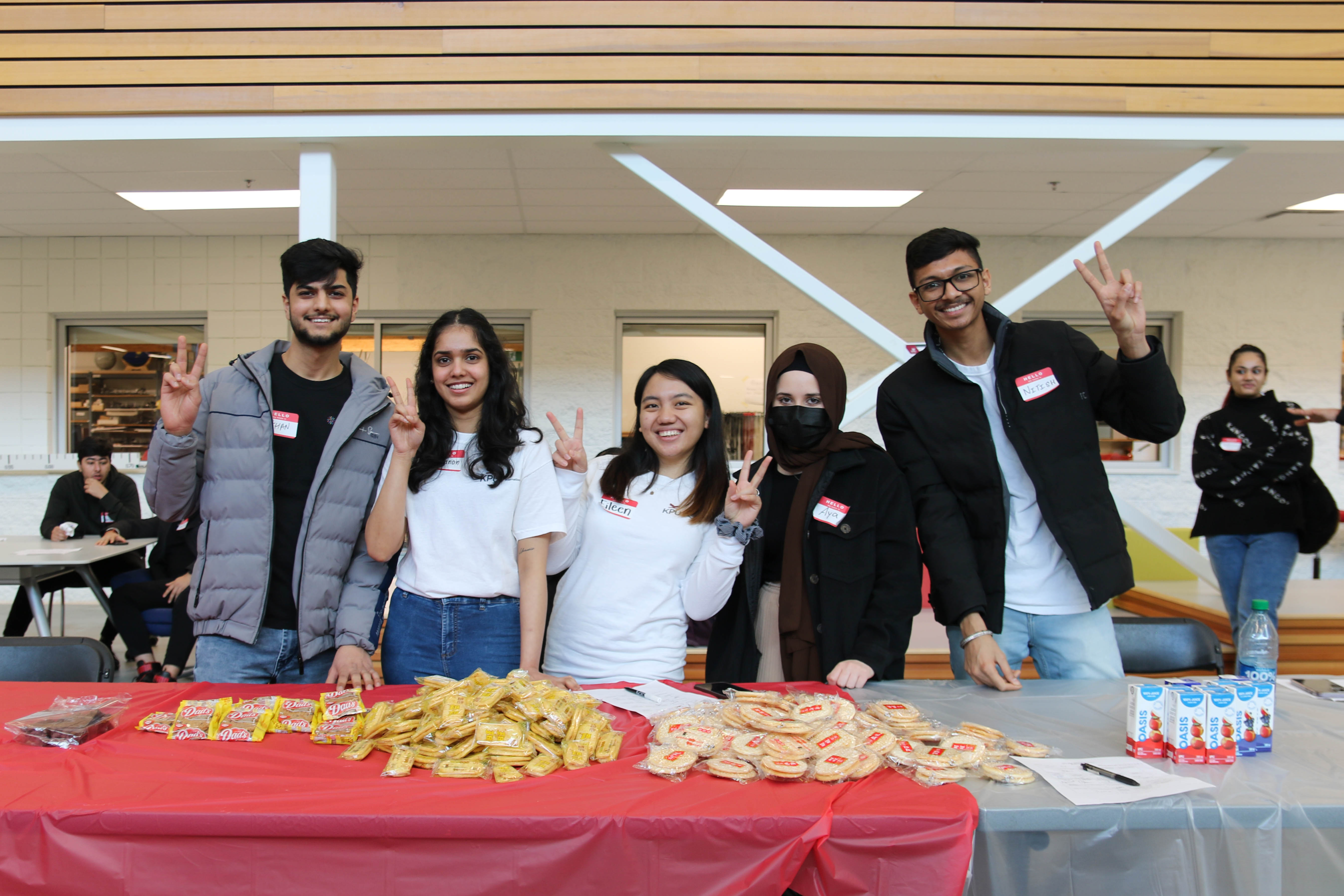 Group of student life volunteers at an event inside the Fir building.
