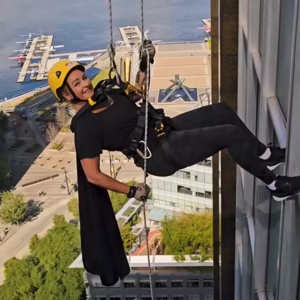 Lana Mihell rappelling down the Guiness Tower in Vancouver 