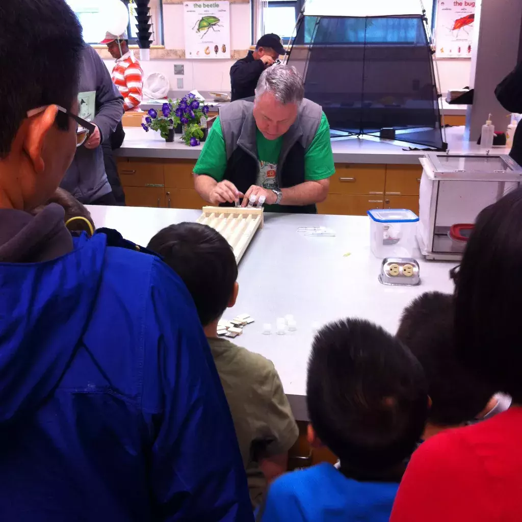 Plant Health instructor Cameron Lait prepares cockroach racing in KPU's Bug Lab for some curious onlookers at the 2014 Science Rendezvous.