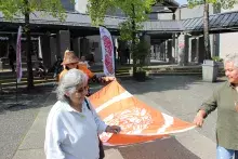 Indigenous Elders carrying KPU's Reconciliation flag to be raised in the Surrey campus courtyard